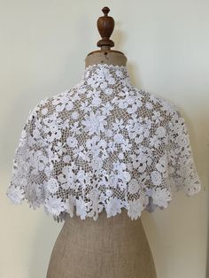 A stunning antique Irish crochet lace capelet made by hand in white cotton. It has a grown on collar and has many beautiful three dimensional florals within the design. This would make an ideal cover up to be worn with a wedding dress or a fabulous large collar over a contrast coloured dress. Length at back including the collar : 15" Length at front edge including the grown on collar : 15 1/2" Top edge of collar : 16" Hem circumference: 84" Good antique condition. White Crochet Lace In Vintage Style, White Victorian Crochet Lace, Wedding Capelet, Lace Capelet, Crochet Capelet, Lace Cape, Crochet Wedding, Crochet Collar, Irish Lace Crochet