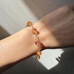 This exquisite bracelet showcases stunning Padparadscha Sapphire (simulated) faceted rondelles, meticulously hand-wired in 14K gold-filled material. Measuring 17.5 cm in length with a 2.5 cm extension, it is elegantly finished with a 14K gold-filled lobster claw clasp. Perfect for any occasion, this bracelet makes a unique and charming gift. FEATURES ◊ Padparadscha sapphire (simulated) faceted rondelles in pink orange colour ◊ 14K gold-filled wire ◊ All components of the bracelet are 14K gold-filled to ensure the highest quality. ◊ Bracelet length is approximately 17.5 cm with a 2.5 cm extender ◊ 100% nickel-free, suitable for sensitive skin JEWELRY PACKAGING ◊ All my jewellery is packaged in gift boxes, ready for gifting! PREMIUM GIFT-WRAP ◊ Add an extra special touch to your gifts by sel Bracelet Elegant, Orange Stone, Padparadscha Sapphire, Orange Colour, Sapphire Bracelet, Elegant Bracelet, Unique Gifts For Her, Premium Gift, Charm Gift