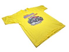 1984 Roach Monster Truck heat transfer on a 70s, yellow, single stitch, Screen Stars, 50/50 shirt. I'm hyped on the way this one came out, the transfer adhered great, and the colors are amazing! Please be mindful this was a 40 year old iron-on on a vintage tee, very rare for they to come out like this one. Size Mens Large 21" across the shoulders 22" across the chest 26.6" long Note: These are vintage heat transfers as old as 1960's. They are not as resilient as modern ones, these will crack over time as you wash and wear the shirt. For longevity, hand-wash cold, or delicate wash cold, and air dry. The Monster Mash, Rhinestone Tees, Monster Mash, Vintage Tee, Monster Truck, 50 50, Vintage Tees, Very Rare, Air Dry