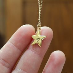 This little star is just the cutest. It has a heart in its center, on both sides!Cast in solid sterling silver and dipped in gold, it hangs from a gold filled chain. Choose your length from the drop down menu.The charm is 5/8" tall and 1/2" wide. Jewelry is shipped in a gift box without a receipt. I ship USPS First Class, shipping upgrades available at checkout. Simple Gold Necklace, Star Necklace Gold, Star Charm Necklace, Gold And Silver Jewelry, Solid Gold Necklace, Gold Charm Necklace, Funky Jewelry