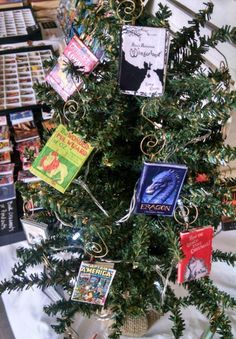 a christmas tree decorated with books and candy canes is on display in a store