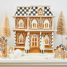 an elaborate gingerbread house is displayed on a mantle