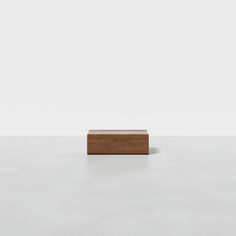 a wooden block sitting on top of a white floor