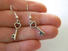 Skeleton key charms hang from silver colored ear wire. The keys have a heart design. The earrings are 1.5 inches long. Heart Skeleton Key, Heart Skeleton, Key Earrings, Beaded Jewelry Earrings, Key Charms, Skeleton Key, The Keys, Small Heart, Etsy Earrings Dangle