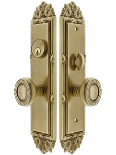 an ornate brass door handle with two knobs on the front and back sides, both facing each other