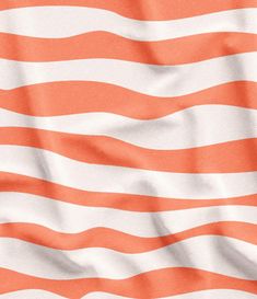 an orange and white striped fabric with wavy lines in the center, as if it is waving