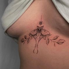 a close up of a woman's stomach with a butterfly tattoo on her side