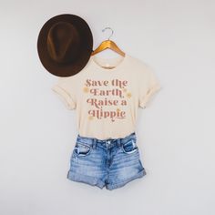 Women's Save The Earth Raise a Hippie Graphic Tee is perfect for Earth Day and beyond! Great new neutral design for spring and summer. Makes a great gift for your like minded friends and family! Dark shirt colors here: https://www.etsy.com/listing/970805330/womens-save-the-earth-raise-a-hippie?ref=shop_home_active_1&frs=1 Looking for more vintage/retro inspired tops and tees? Check these out: https://www.etsy.com/shop/TheGraphicPeach?ref=seller-platform-mcnav&section_id=33890848 Our shop Spring Graphic Tee Shirt With Funny Text, Spring Cotton Shirt With Funny Text, Love Your Mother Earth, Vegan T Shirt, Love Your Mother, Minimalist Graphic Design, Save The Earth, Mother Shirts, Bella Canvas Tees