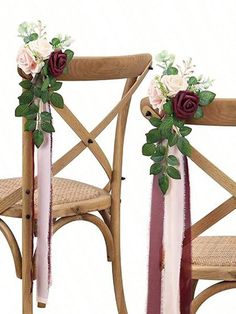 two wooden chairs decorated with flowers and ribbons