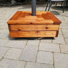 a wooden box sitting on top of a sidewalk