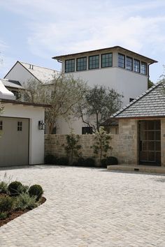 a large house with two garages in front of it