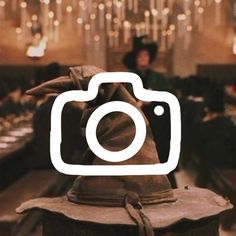 a camera sitting on top of a wooden table in front of a chandelier