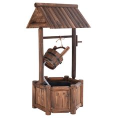 an old fashioned wooden wishing well with a cup hanging from it's roof,