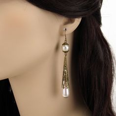 Contessa Caterina Sforza Teardrop Pearl Earrings in Antique Bronze There are times for heavy, ornate jewelry and then there are times that just a touch of elegance will take your Renaissance costume to a whole new level. These enchanting Contessa Caterina Sforza teardrop pearl earrings are the ultimate statement in understated luxury. Inspired by the character Caterina Sforza from the Showtime series "The Borgias", each alluring earring features a luminous round pearl capped with beautiful antiq Ornate Bronze Earrings, Elegant Bronze Dangle Jewelry, Elegant Antique Gold Jewelry For Party, Elegant Antique Gold Party Jewelry, Elegant Nickel-free Brass Pearl Earrings, Elegant Antique Gold Nickel-free Earrings, Elegant Brass Chandelier Earrings With Long Drop, Elegant Antique Gold Drop Earrings, Ornate Antique Gold Dangle Jewelry