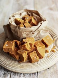 pieces of peanut butter fudge on a plate with a paper bag in the background