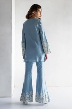 Powder blue straight kurta featuring floral thread embroidery on the sleeve hem. Paired with a co-ordinating bell bottom pant. - Aza Fashions Blue Sharara With Chikankari Embroidery For Spring, Blue Chikankari Embroidery Sharara For Spring, Blue Chikankari Embroidered Sharara For Spring, Spring Blue Sharara With Chikankari Embroidery, Blue Embroidered Bohemian Palazzo Set, Blue Long Sleeve Palazzo Set With Floral Embroidery, Blue Salwar Kameez With Intricate Embroidery For Spring, Blue Embroidered Sets With Straight Pants, Spring Blue Chanderi Palazzo Set