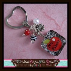 a heart shaped keychain with some charms attached to it