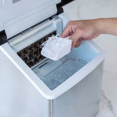 a person is cleaning an ice chest with a rag