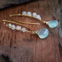 Truly made for any woman’s inner princess. Beauty and grace runs right through these handcrafted gold earrings. Blue Chalcedony instills a sense of belonging and encourages kindness and generosity toward others. Blue Chalcedony is great for promoting a sense of peace, joy, self-nurturing and balance. Chalcedony helps to relieve one of negative emotions, bringing a greater sense of overall happiness into one's life. Moonstone is believed to be a stone of destiny. It is strongly connected to the m Handmade Chalcedony Earrings For Gifts, Handmade Chalcedony Earrings As Gift, Handmade Gold Earrings With Chalcedony, Chalcedony Earrings With Ear Wire For Gift, Blue Moonstone Earrings For Gift, Handmade Chalcedony Drop Earrings, Gold Chalcedony Dangle Earrings, Stone Of Destiny, Moonstone Earrings Gold