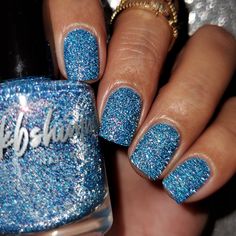 Chill Out is a sky-blue nail polish with twinkling silver reflective glitters that echo falling snow. Loaded with a multichrome shimmer, this shade shows off a rainbow of hues. Glistening gold, pink, red, and warm orange easily pop against the cool blue base, while some angles even show hints of lime. Best in two coats, use with Smooth Moves and Clearly On Top for a glass-like finish, or wear without either for a unique textured look.There's a bit of magic when the first flakes of snow fall up N Sparkle Nails Short, Sky Blue Nail Polish, Reflective Nail Polish, Sky Blue Nails, Reflective Nails, Glitter Shorts, Baby Blue Nails, Snow Fall, Falling Snow