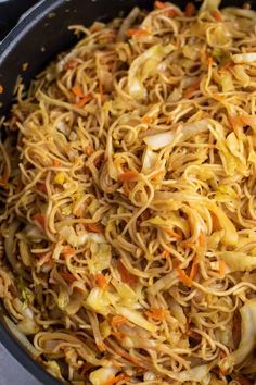 a pan filled with noodles and vegetables on top of a stove