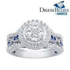 a white gold ring with blue and white diamonds on the band, in front of a dress blues logo