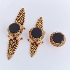 three pairs of black stone and gold tone earrings