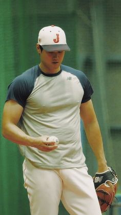 a baseball player holding a ball and glove