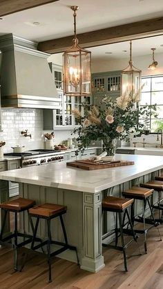 a large kitchen with an island in the middle and stools at the counter top