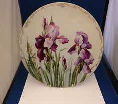 a plate with purple flowers painted on it