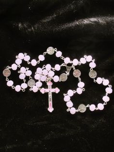 "This Lutheran rosary is made with 8x6mm faceted rondelles, 9mm Tree of Life flat pewter rounds, and an Italian made pink enameled crucifix. It measures about 21 inches around the body and has a 4.5\" cross drop. I hand turned the silver plated links. This rosary will be slipped into a velvet bag and shipped in a bubble mailer." Pink Spiritual Rosary Bracelet With 8mm Beads, Pink 8mm Bead Spiritual Rosary Bracelet, Pink 8mm Beads Rosary Bracelet, Handmade Pink Rosary For Healing, Pink Beaded Rosary, Handmade Pink Rosary In Cross Shape, Pink 8mm Beads Crucifix Jewelry, Handmade Pink Rosary With Round Beads, Adjustable Pink Cross Rosary