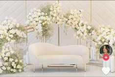 a white couch sitting in front of a flower covered wall with an instagram photo