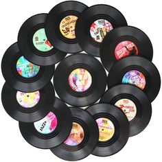 twelve black vinyl records are arranged in a circle