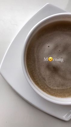 a cup of coffee with the word morning written on it