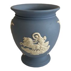 a blue vase with an image of a horse and rider on the front is shown