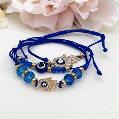 BELLA - Silver & Blue Evil Eye String Bracelet A lovely adjustable string bracelet that showcases evil eye charms with some blue beads  The perfect gift for a young person. Delivered in a beautiful soft suede pouch to store and keep it safe. Like my facebook page to keep updated with new designs. www.facebook.com/keepsakepins Thank you for visiting :-) Blue Evil Eye, String Bracelet, Evil Eye Charm, Evil Eye Bracelet, Religious Jewelry, Soft Suede, Evil Eye Jewelry, Blue Beads, Evil Eye