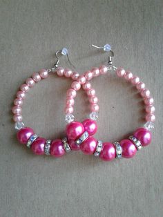 Pink pearl beaded hoop earrings...using light pink pearl beads, hot pink pearl beads, clear bicone beads, and rainbow colored rhinestone spacers.  Measurements: 3 inches in length.. Has some weight to them, but they won't bog your ears down! Thanks for looking :-) Handmade Pink Pearl Earrings, Handmade Pink Round Pearl Earrings, Pink Pearl Round Earrings, Pink Round Pearl Earrings With Ear Wire, Beaded Pearl Hoop Earrings For Party, Pearl Beaded Hoop Earrings For Parties, Pink Hoop Earrings With Dangling Beads For Gift, Pink Pearl Earrings With Round Ear Wire, Pink Pearl Jewelry With Ear Wire