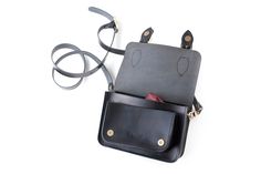 A high quality beautifully handmade leather satchel. Made from 100% real heavyweight leather (cowhide) in a choice of traditional colors. Size: 20 x 14 x 8 cm 100% Italian vegetable tanned leather Front double brass buckle strap Adjustable shoulder strap Inside zip pocket For EU customers: All your orders between $ 20 and $ 300 are shipped via Landmark Global and do not require customs fees. This model in other colors: https://www.etsy.com/shop/ChurchillAtelier?section_id=20867507 -------------- Black Saddle Shoulder Bag With Leather Lining, Black Leather-lined Saddle Shoulder Bag, Black Satchel Shoulder Bag With Smooth Grain, Classic Black Flap Bag For Gift, Classic Black Flap Bag Gift, Classic Black Flap Bag As Gift, Black Smooth Grain Satchel Shoulder Bag, Classic Black Flap Bag For Gifts, Black Leather-lined Saddle Bag For Everyday Use