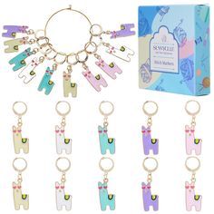 an assortment of key chains and charms in various colors with a box behind them on a white background