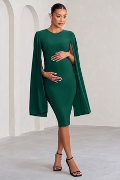 Get set to wow 'em all with our stunning "Hey Mama" maternity cape midi dress! Designed to flatter and sculpt your bump. this gorgeous dress certainly serves up the high-impact glamour. It features dramatic statement cape sleeves that are balanced out by the demure high neckline and mid-length hem. Features- Cape design- High neckline- Crepe fabricSizingModel is 5'9 and wears UK size 8 / US size 4Fit InformationMade from Jersey (95% Polyester 5% Elastane)Total length from top of shoulder: 109cmS