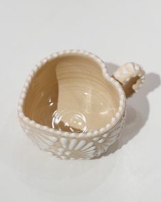 a small white bowl sitting on top of a table