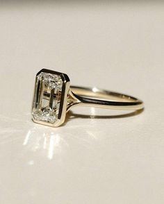 a diamond ring sitting on top of a table