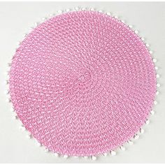 a pink and white round rug with pom - poms on the bottom,