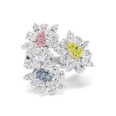 High jewelry meets fun and contemporary with this multi-stone flower ring. White diamonds blossom around Fancy colored diamonds to display a delicate, sculptural look crafted to stand out. 0.31CT Pear Shape Fancy Pink Diamond - SI1 Clarity, GIA#5211317622 0.34CT Pear Shape Fancy Blue Diamond - SI2 Clarity, GIA#2171888908 0.78CT Pear Shape Intense Yellow Green Diamond - SI2 Clarity, GIA# 2171459074 4.68CT Pear Shape and Marquise Natural White Diamonds Luxury Elegant Multi-stone Flower Ring, Luxury Multi-stone Diamond Ring, Fancy Color Diamond Ring, Colored Diamond Rings, 2024 Color, Green Diamond, Diamond Shop, Fancy Color Diamonds, Diamond Jewellery