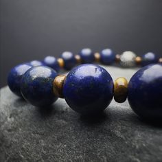 Introducing our Men's Lapis Lazuli Beaded Bracelet, a harmonious blend of style and spirituality. This gemstone bracelet, meticulously crafted with natural Lapis Lazuli beads, exudes a minimalist charm that effortlessly complements any ensemble. The 925 Sterling Silver detailing adds a touch of sophistication, making it a versatile accessory for any occasion. Designed for both style and strength, this stretch bracelet features Yellow Tiger Eye gemstones, renowned for their grounding properties. Bracelet Mens, Lapis Lazuli Stone, Tiger Eye Beads, Mens Beaded Bracelets, Tiger Eye Stone, Tiger's Eye, Custom Bracelets, Natural Beads, Gemstone Bracelet