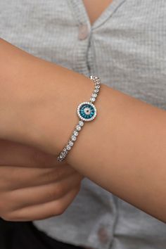 Evil Eye Waterway Silver Bracelet  ♥ ✔️Metal Used: 925 Sterling Silver ✔️Weight : 9,60 Gr ✔️Chain Length : 17+4 Cm ✔️Stone Type : Zircon ✔️Coating : Rhodium Plated ⚠️Care: It does not darken as long as contact with substances such as Perfume, Water, Alcohol, Cream, Bleach is avoided. -NRZ998674 Silver Evil Eye Bracelet With Cubic Zirconia, Silver Cubic Zirconia Evil Eye Bracelet Gift, Adjustable Silver Round Evil Eye Bracelet, Sterling Silver Crystal Bangle Bracelet, Silver Crystal Bracelet With Hand Set Stones, Silver Elegant Evil Eye Bracelet, Elegant Silver Evil Eye Bracelet, Sterling Silver White Gold Crystal Bracelet, Silver Hand Set Chain Bracelet As Gift