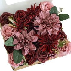 a box filled with lots of pink and red flowers