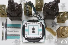 an assortment of decorative items displayed on a white tablecloth with blue and green accents