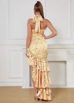 Elevate your wardrobe with our Floral Print Ruffle Hem Tassel Decor Dress. This stunning yellow maxi dress features a flattering halter-neck, delicate satin fabric, and feminine ruffle hem. The beautiful floral print and playful tassel details add a touch of Bohemian elegance. Perfect for any occasion, this dress will make you feel confident and stylish. Fabric: Slight Stretch Material: Polyester Fiber Feminine Yellow Sleeveless Maxi Dress, Satin Maxi Dress For Garden Party, Feminine Yellow Maxi Dress, Spring Satin Halter Dress, Spring Halter Maxi Dress With Ruffles, Spring Maxi Length Halter Dress With Ruffles, Yellow Ruffle Hem Maxi Dress For Spring, Chic Yellow Maxi Dress With Ruffle Hem, Chic Halter Neck Maxi Dress With Ruffle Hem