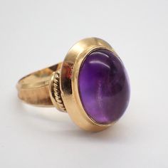 Vintage 18k (.750) yellow gold ring, decorated with oval Amethyst cabochon. This stately ring is a size 7, it is 18.8 mm at the widest, weighing 7.6 grams. EA5537 Formal Domed Signet Ring With Cabochon, Formal Yellow Gold Signet Ring With Oval Cabochon, Luxury Yellow Gold Amethyst Ring Oval Cabochon, Formal Yellow Gold Amethyst Ring With Bezel Setting, Oval Cabochon Signet Ring For Formal Events, Oval Cabochon Signet Ring For Formal Occasions, Oval Amethyst Ring In Yellow Gold With Polished Finish, Oval Yellow Gold Amethyst Ring With Polished Finish, Yellow Gold Oval Cabochon Rings For Formal Occasions